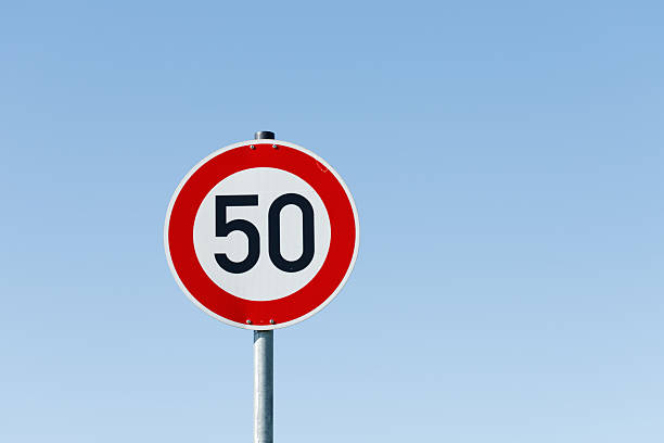 istock German Speed Limit 50 Sign against Blue Sky 2229099154