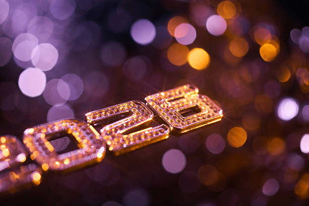 istock Bold Glittering 2026 Typography with Purple and Orange Festive Bokeh Lights 2229108444