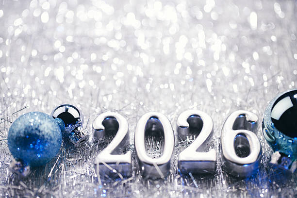 istock Elegant Silver 2026 Numbers with Blue and Silver Ornaments on Shiny Tinsel Background 2229108470