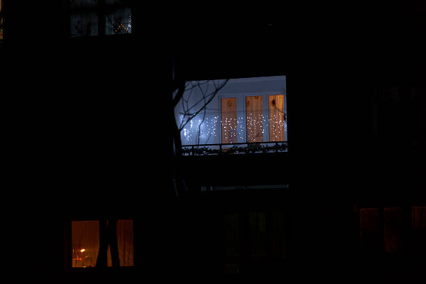 istock A person is standing quietly in front of a window at night 2229112921
