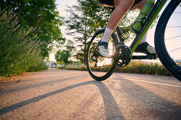 istock Cyclist pedaling on a sunny path at sunset 2229115032
