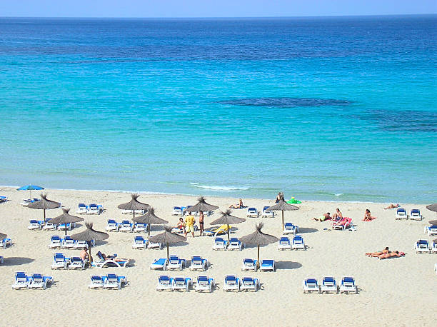 Ibiza is one of the Balearic Islands, a Spanish archipelago located in the Mediterranean Sea. It is known for the lively nightlife of Ibiza Town and Sant Antoni, where major European nightclubs have summer outposts. The island also boasts quiet villages, yoga retreats, and beaches, ranging from Platja d'en Bossa, lined with hotels, bars, and shops, to quieter sandy coves, backed by pine-covered hills, found all along the coast.