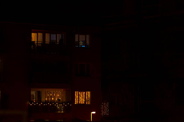 istock Blurry picture of a building at night with lit windows 2229117831