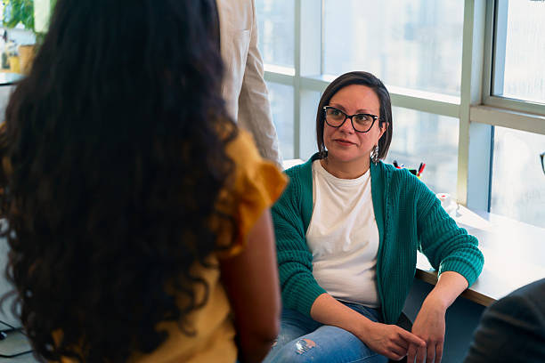 istock Latin american coworkers discussing in modern office 2229118361