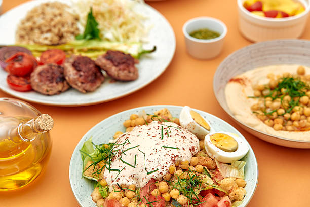 istock Delectable Mediterranean Feast Featuring Fresh Salads, Flavorful Grilled Meats, and Savory Dips Artfully Arranged on a Vibrant Table Setting 2229122569