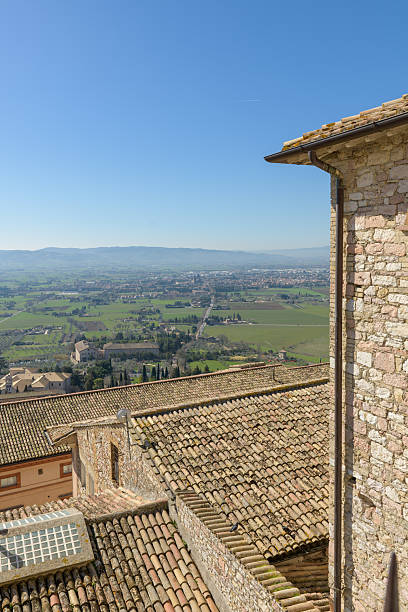 istock Elevated view from Assisi over olive groves and medieval rooftops toward the Umbrian plain and distant hills, Umbria, Italy. 2229125364