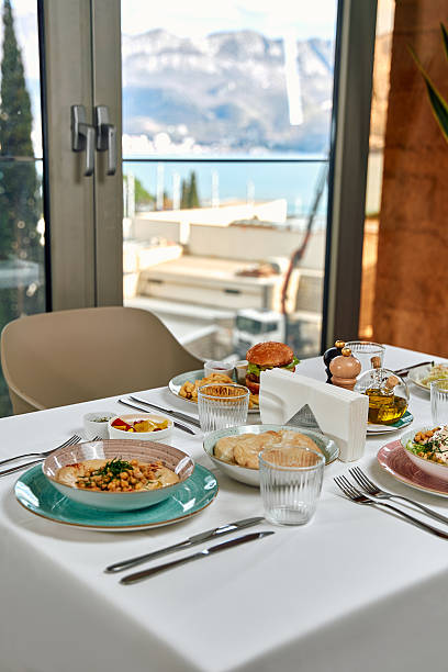 istock A Luxurious Dining Experience Featuring Exquisite Dishes with Captivating Views of Nature Through Large Windows 2229125861