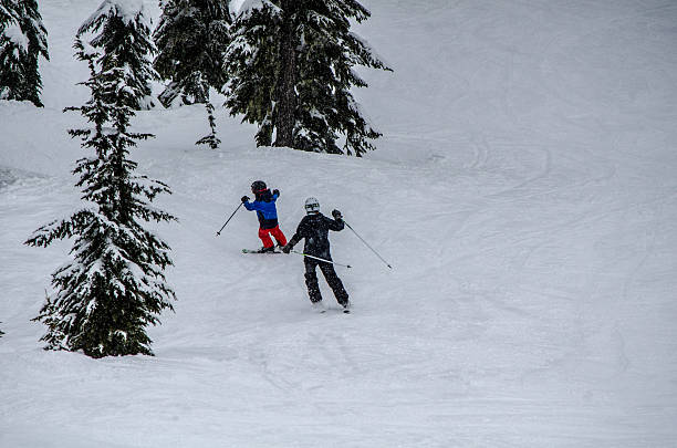 Skiing siblings taking on the slopes at their local ski hill.