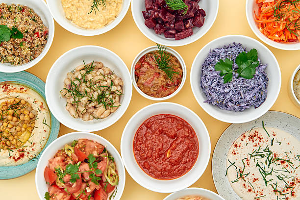 A Vibrant Array of Colorful Dishes Showcasing Diverse Ingredients and Textures on a Yellow Background, Celebrating Culinary Creativity and Flavorful Combinations