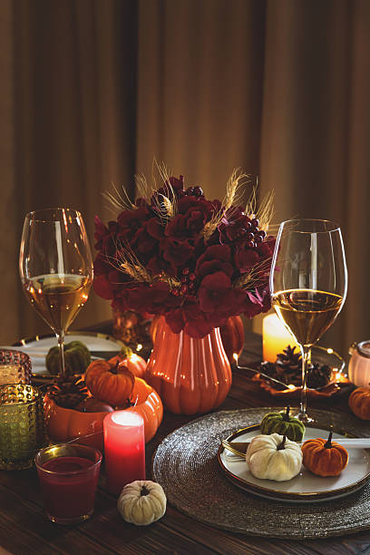istock Thanksgiving table setting with decorative pumpkins, candles and string lights on dark wooden table 2229127022