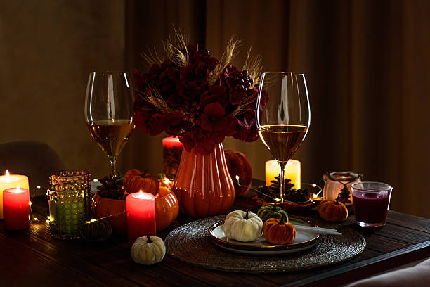 istock Thanksgiving table setting with decorative pumpkins, candles and string lights on dark wooden table 2229127309