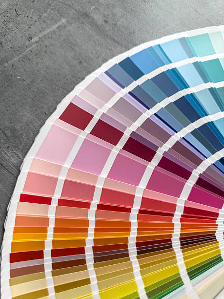 istock catalog of paints with different samples on grey desk.  Rainbow sample colors catalogue. 2229127616