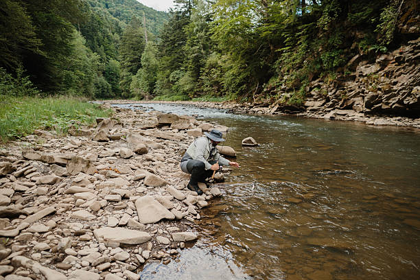 istock Fisherman releasing trout in mountain river during summer day 2229128385