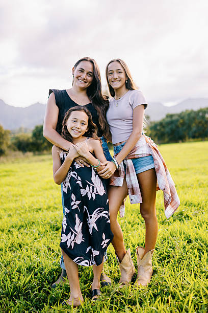 istock Mother Embraces Daughters on Kauai Hawaii 2229131276