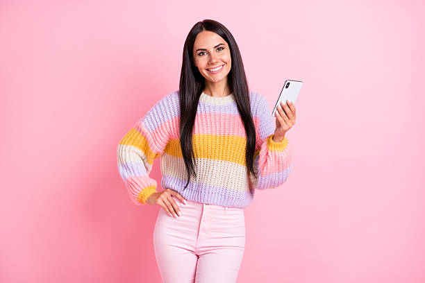 istock Portrait of attractive cheerful long-haired girl using device gadget browsing post smm media isolated over pink pastel color background 2229132982