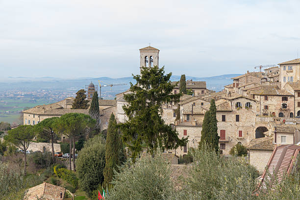 istock Elevated view from Assisi over olive groves and medieval rooftops toward the Umbrian plain and distant hills, Umbria, Italy. 2229133149