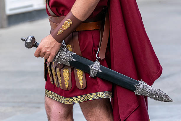 Roman legionary in traditional armor holding an ornate gladius sword.