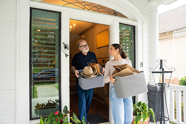 istock Senior man getting help from his adult daughter while moving boxes at home. 2229135805