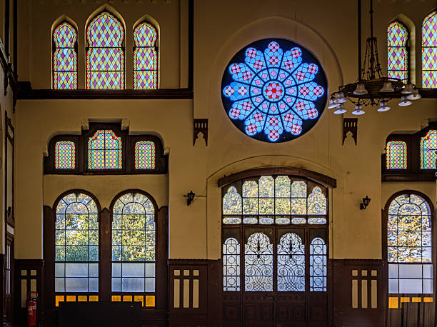 Istanbul, Turkey - November 10 2023: Grand interior of historic Sirkeci Terminal with ornate wooden panels and star patterned stained glass windows