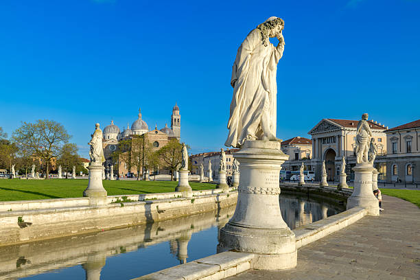 istock Prato della Valle is a large square in Padua, Italy, with a central elliptical island, surrounded by a canal and statues. 2229137528