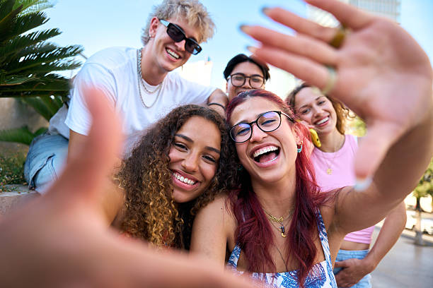 istock Group of young happy students taking a selfie outdoors, smiling and having fun 2229138497