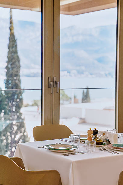 istock A Serene Dining Experience with Scenic Views Overlooking Mountains and Water, Featuring Elegant Table Settings and Modern Decor in a Bright, Airy Space 2229139442