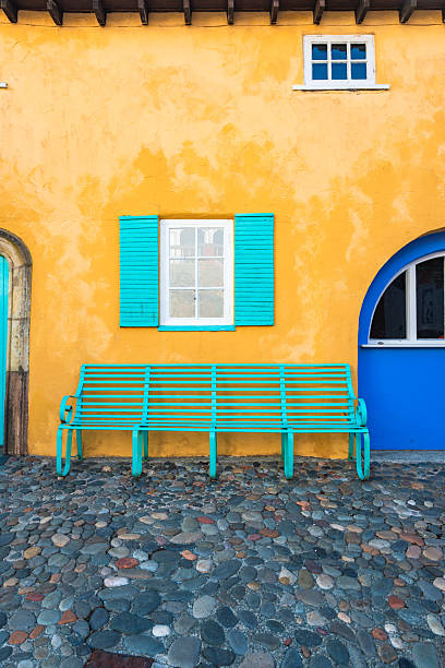 Turquoise bench in front of colorful facade