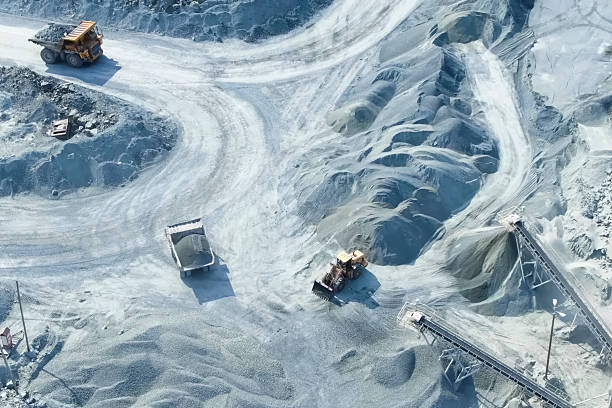 istock top-down view of mining trucks driving along the road inside an 2229141260