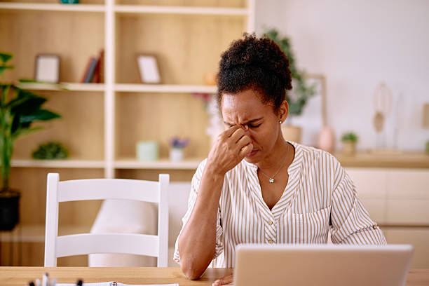 istock Stressed businesswoman having a headache while working from home 2229142496