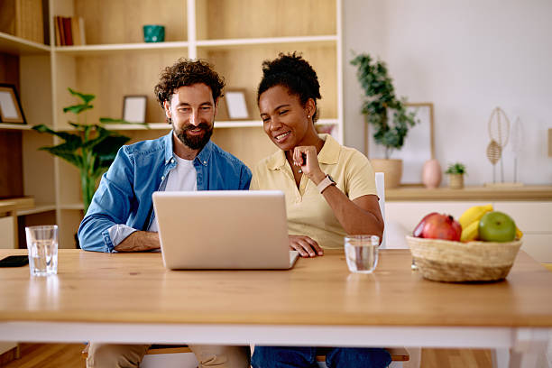 istock Couple working from home using laptop and smiling 2229142542