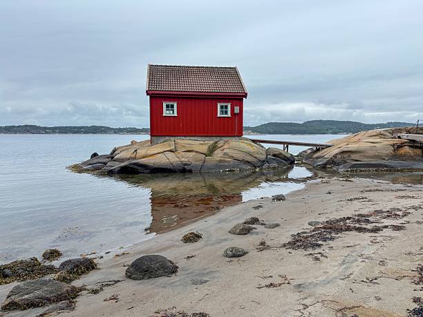 istock Solitary red cabin by the sea 2229143255