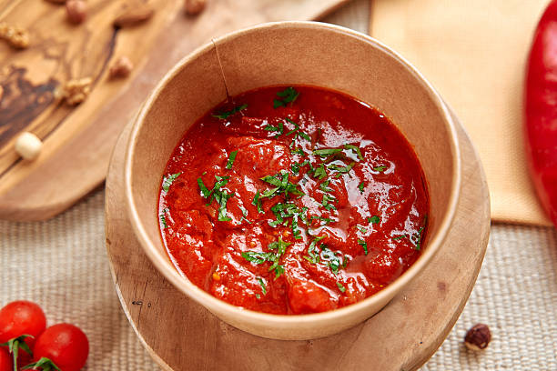 A Rich, Flavorful Tomato Sauce Garnished with Fresh Herbs in a Rustic Bowl Perfect for Pasta or Dipping Accompanied by Fresh Vegetables