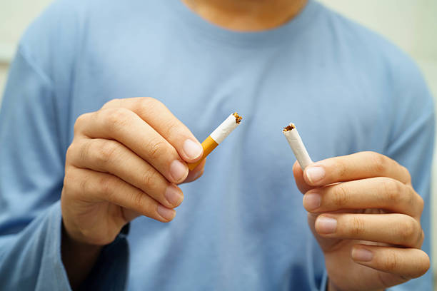 istock Quit smoking, Asian man breaking destroy cigarette in hand. 2229151053