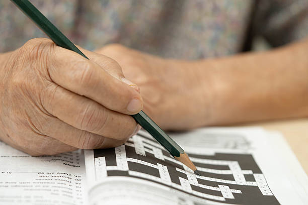 istock elderly woman playing sudoku puzzle game. 2229151232