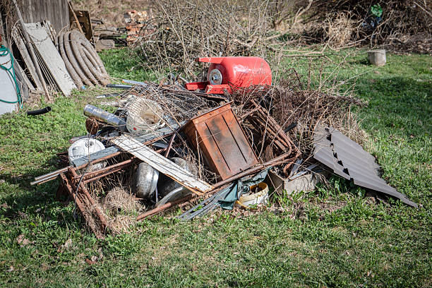 Discarded Scrap Metal and Old Equipment Pile in Rural Yard.