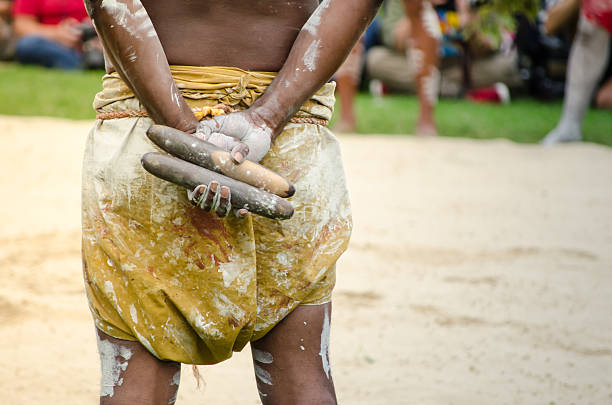 Australian aboriginal people holding Traditional Wood Claves percussion instruments at \