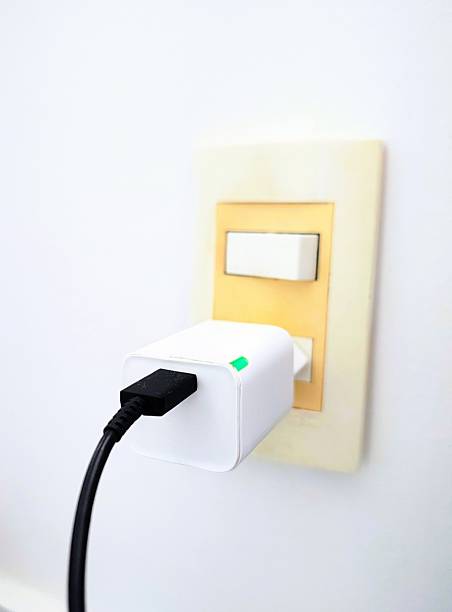 istock Cell phone charger plugged into the socket 2229153951