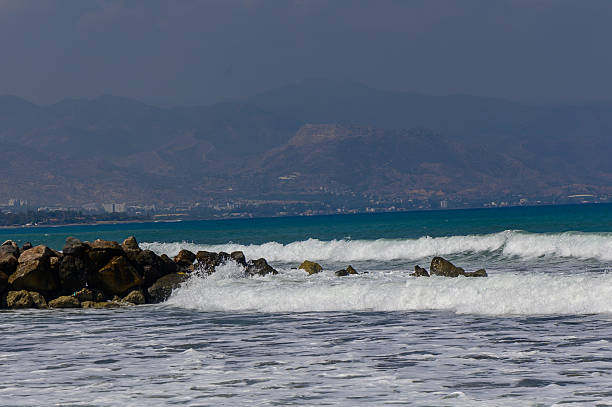 Crystal clear water of the Mediterranean Sea gently touching the sandy coastline of Cyprus. Serene summer day by the sea.