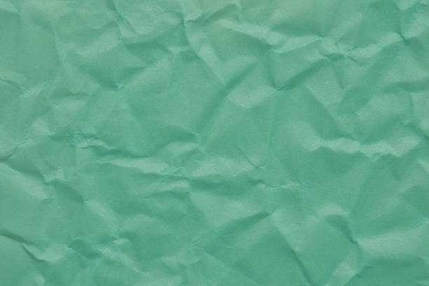 Crumpled Turquoise Paper Creating a Textured Background for Creative Projects and Designs in an Artistic Setting