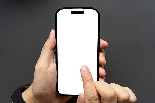 istock Hand Touching Smartphone with Blank White Screen on Dark Background. finger touching the display, isolated against a dark background. Ideal for app mockups, UI presentations, and technology concepts. 2229155635
