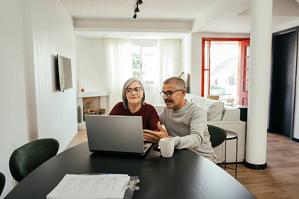 istock Elderly couple using a laptop, searching for an apartment online 2229155738