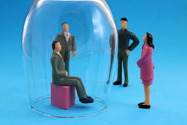 istock Leading executive trapped in a glass capsule that separates him from his team 2229161359