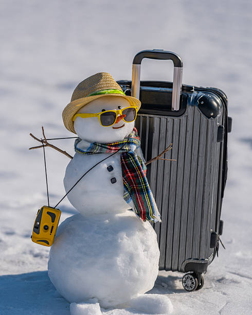 istock Snowman with suitcase. Winter vacation. Christmas theme. 2229164626