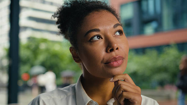 istock Thoughtful African American thinking contemplate pondering decision choosing work entrepreneur woman female girl businesswoman business solve puzzled solution manager consider planning city outdoors 2229169251