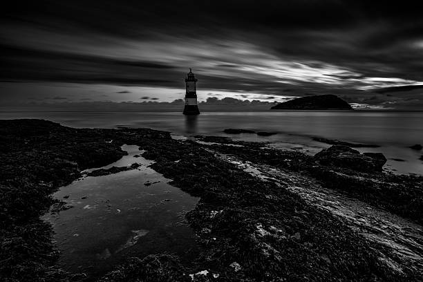 istock Lighthouse at dawn with dramatic clouds in black and white, Penmon Point, Anglesey, Wales, Britain 2229171806