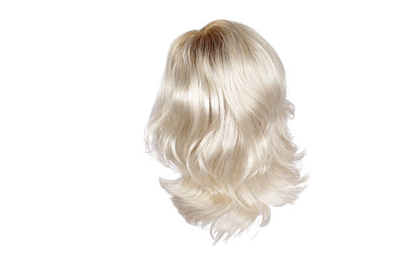 Natural looking ginger wig on white mannequin head. Long straight hair with wavy curls on the plastic wig holder isolated on white background, side view