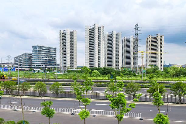 An aerial view shows an urban architectural scene under a blue sky with white clouds