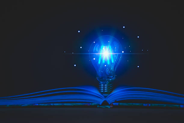 istock Blue glowing light bulb emerges from an open book, symbolizing knowledge, and new ideas. Concepts of innovation, education, and intellectual discovery, with a focus on enlightenment and inspiration. 2229173223