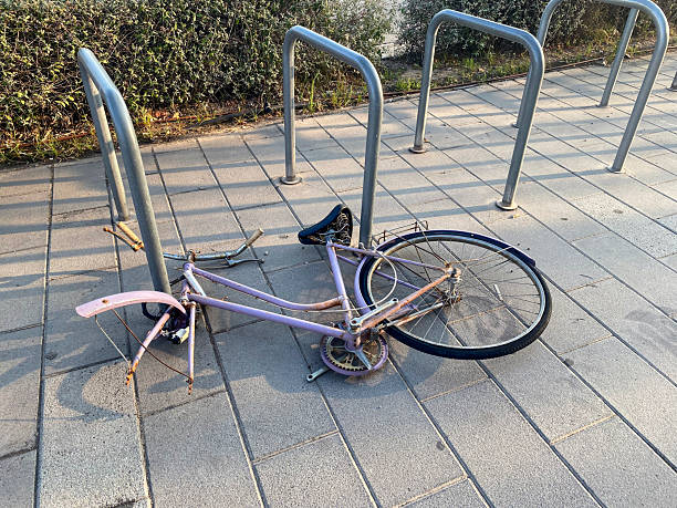 istock Bicycle with left front wheel abandoned in the street 2229174584