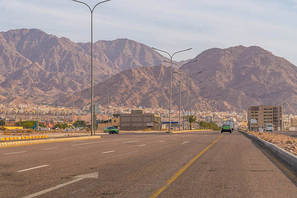 istock Highway 80 from Aqaba, Jordan stretching into rugged desert mountains under clear skies, sparse traffic and vast arid vistas 2229174740